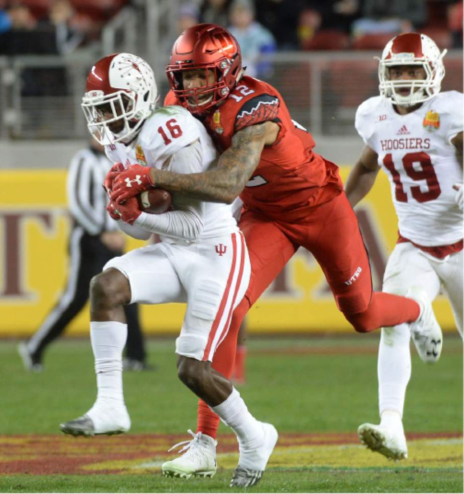 Steve Griffin / The Salt Lake Tribune

Utah Utes wide receiver Tim Patrick (12)***Utah Utes defensive back Justin Thomas (12) is forced to tackle Indiana Hoosiers defensive back Rashard Fant after Fant intercepted a pass during the Foster Farms Bowl at Levi's Stadium in Santa Clara California  Wednesday December 28, 2016.