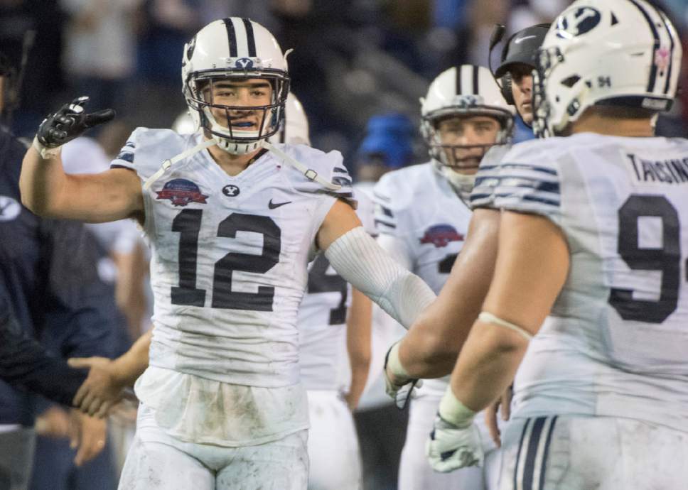 Rick Egan  |  The Salt Lake Tribune

Brigham Young Cougars defensive back Kai Nacua (12) congratulates the offense  after a BYU touchdown, in the Poinsettia Bowl, at Qualcomm Stadium in San Diego, December 21, 2016.