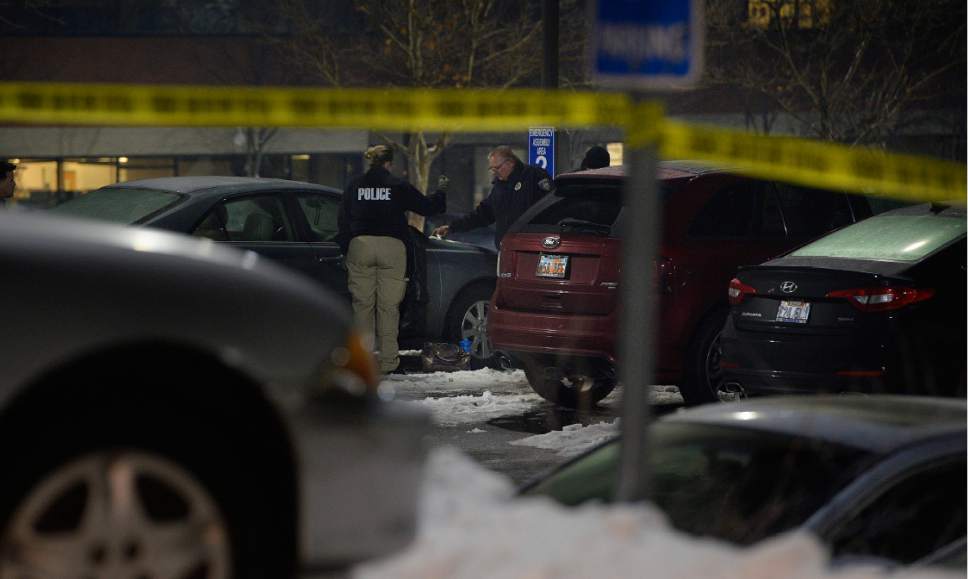Scott Sommerdorf  |  The Salt Lake Tribune  
Police investigate a fatal shooting that took place next to this sedan in the parking lot of ARUP, 500 Chipeta Way, at the University of Utah on Thursday, December 29, 2016.