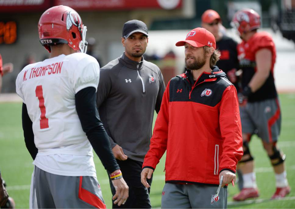 Francisco Kjolseth  |  The Salt Lake Tribune 
Aaron Roderick, right, works with players as the University of Utah football team practices at Rice Eccles stadium on Thursday, April 16, 2015.