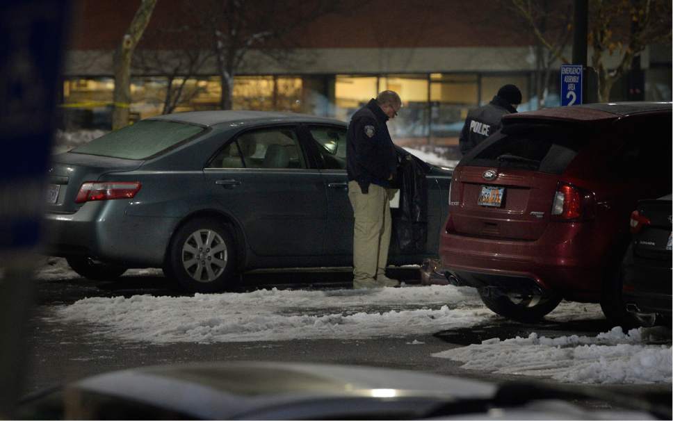 Scott Sommerdorf  |  The Salt Lake Tribune  
Police investigate a fatal shooting that took place next to this sedan in the parking lot of ARUP, 500 Chipeta Way, at the University of Utah on Thursday, December 29, 2016.