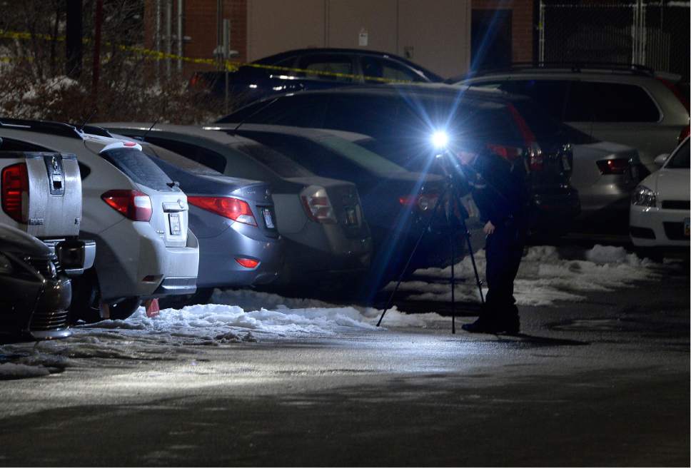 Scott Sommerdorf   |  The Salt Lake Tribune  
A photographer working for the SLC Crime Lab takes photos of the shooting scene in the parking lot of ARUP, 500 Chipeta Way, at the University of Utah on Thursday, December 29, 2016.