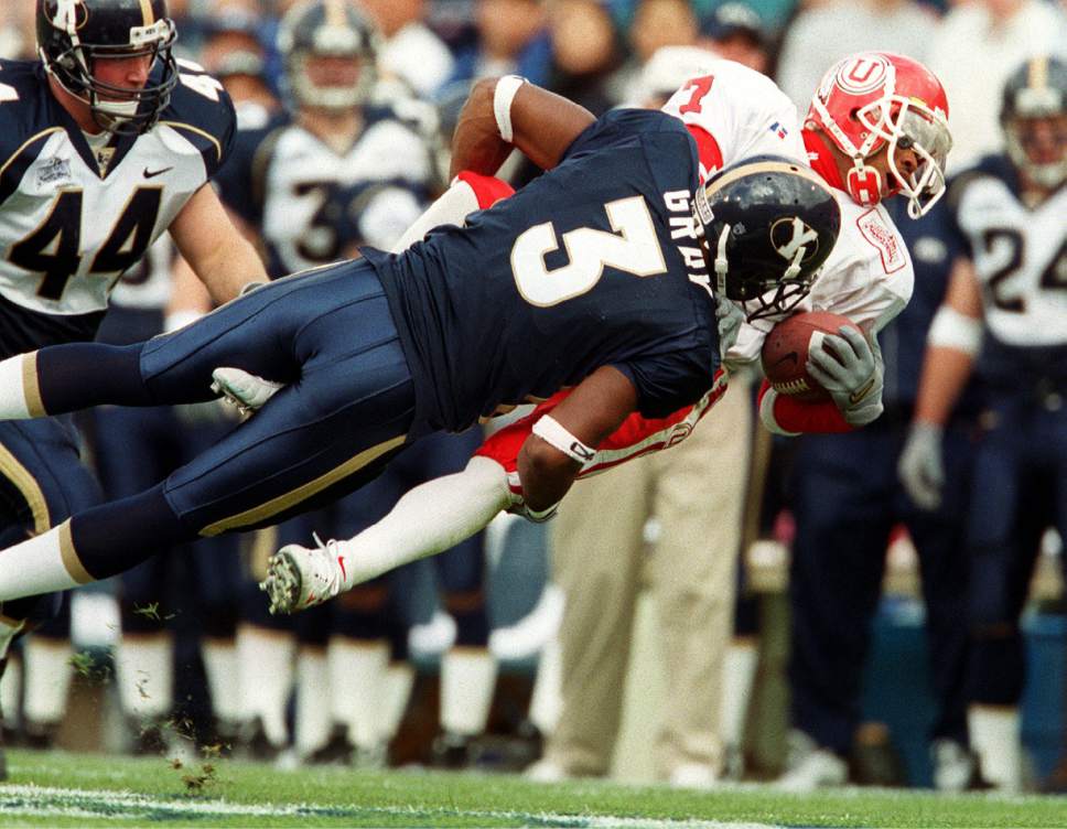 |  Tribune File Photo

BYU's Brian Gray and Ute Steve Smith go airborne during a tackle on November 20, 1999.