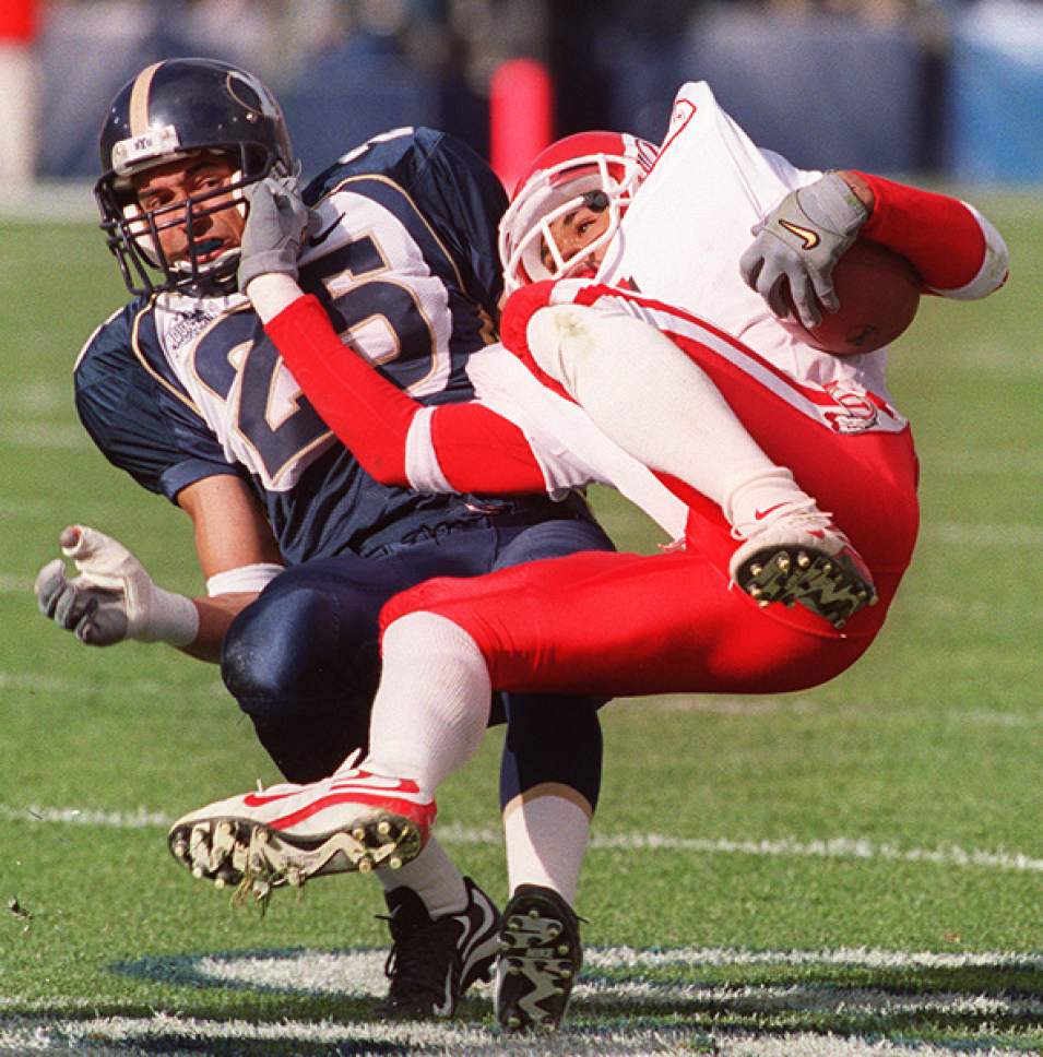 Rick Egan  |  The Salt Lake Tribune

Elan Evans brings Utah's Steve Smith down hard in game action at Cougar stadium on November 20, 1999.