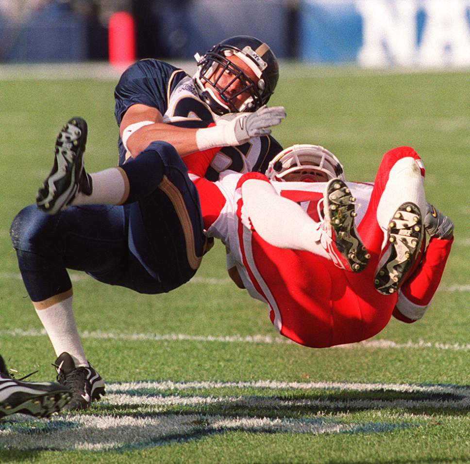 Rick Egan  |  The Salt Lake Tribune

Elan Evans brings Utah's Steve Smith down hard in game action at Cougar stadium on November 20, 1999.