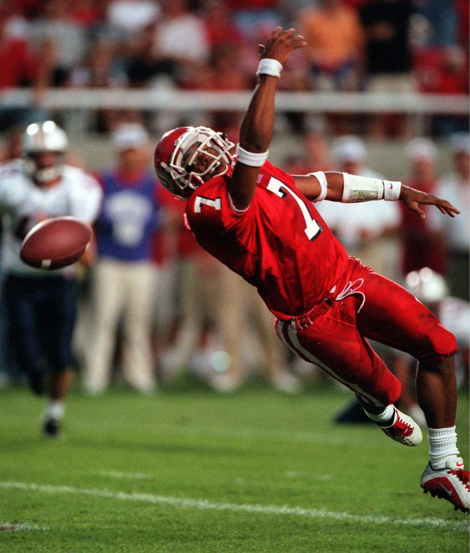 |  Tribune File Photo

Utah wide receiver  Steve Smith stretches but fails to catch the ball during the first half vs Arizona on September 2, 2000.