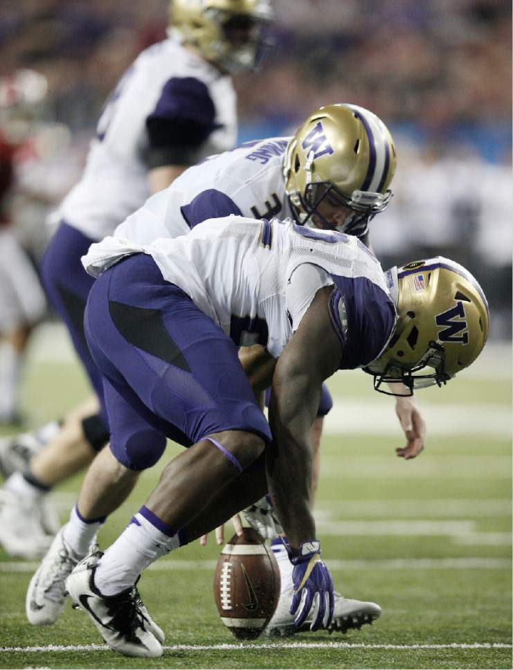 Washington quarterback Jake Browning (3) and Washington running back Lavon Coleman (22) work to recover a fumbled ball against Alabama during the second half of the Peach Bowl NCAA college football playoff game, Saturday, Dec. 31, 2016, in Atlanta. (AP Photo/Skip Martin)