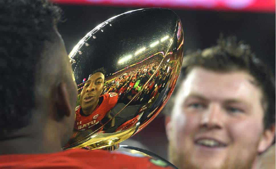 Steve Griffin / The Salt Lake Tribune

Utah Utes defensive end Pita Taumoepenu (50) gets ready to kiss the championship trophy following Utah's victory in the Foster Farms Bowl at Levi's Stadium in Santa Clara California  Wednesday December 28, 2016.
