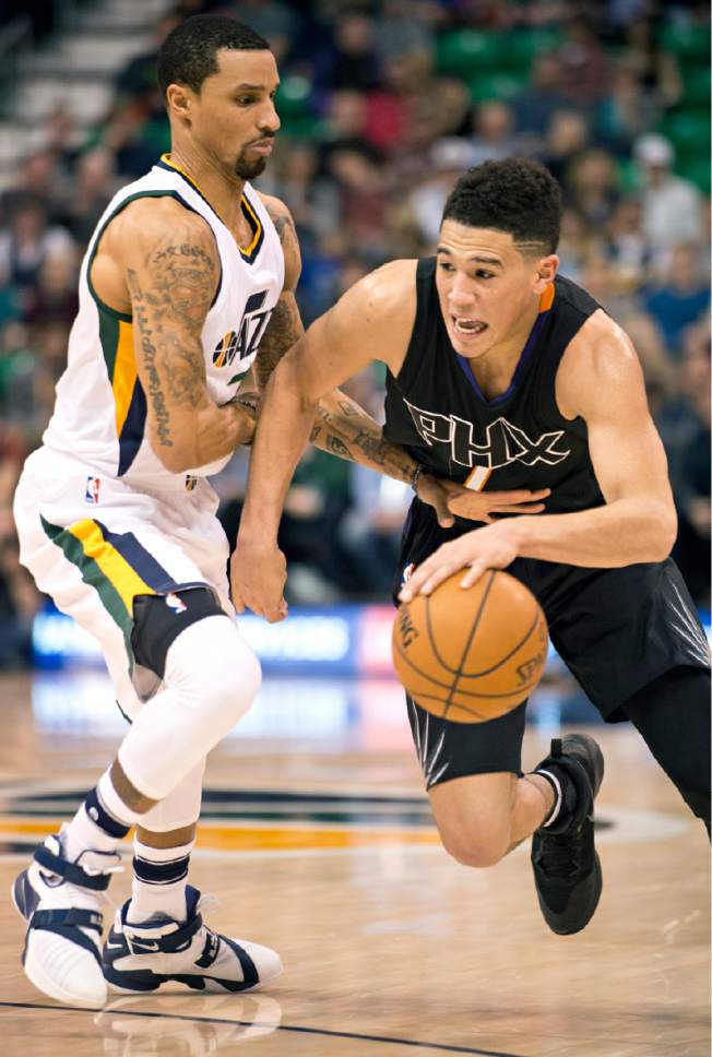 Lennie Mahler  |  The Salt Lake Tribune

Jazz guard George Hill defends Phoenix Suns guard Devin Booker in the first half of a game Saturday, Dec. 31, 2016, at Vivint Smart Home Arena in Salt Lake City.