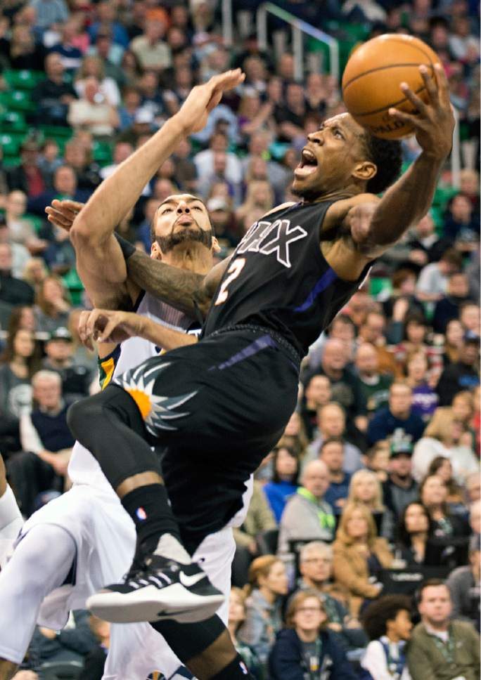 Lennie Mahler  |  The Salt Lake Tribune

Jazz center Rudy Gobert is called for a foul while defending Phoenix Suns guard Eric Bledsoe in the first half of a game Saturday, Dec. 31, 2016, at Vivint Smart Home Arena in Salt Lake City.