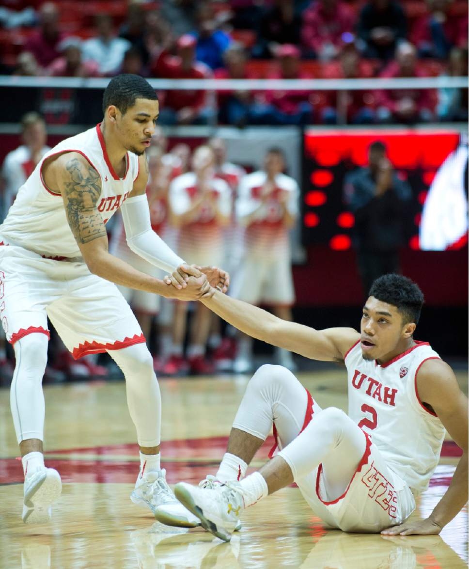 Lennie Mahler  |  The Salt Lake Tribune

Utah guard JoJo Zamora helps up Sedrick Barefield in the first half of a  game against the Colorado Buffaloes on Sunday, Jan. 1, 2017, at the Huntsman Center in Salt Lake City.