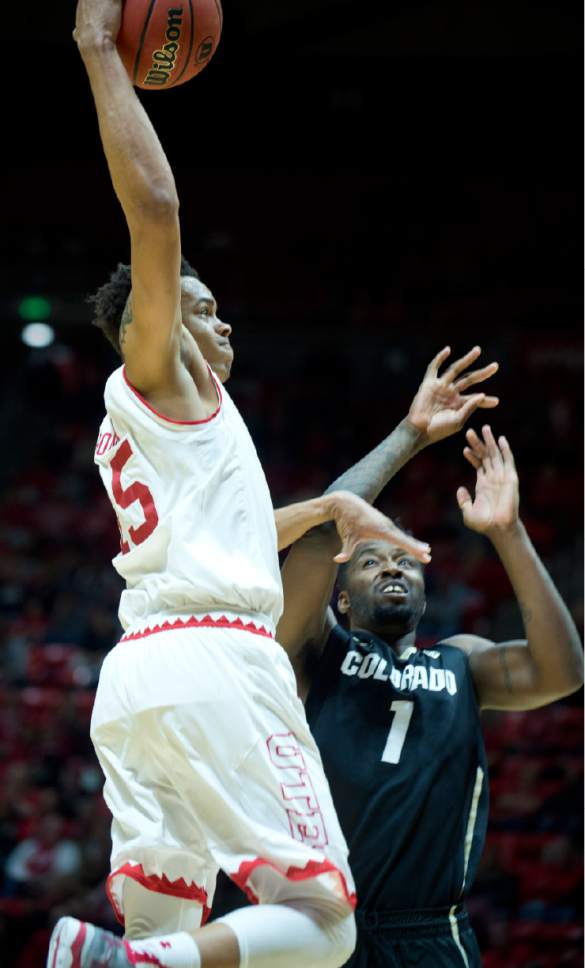 Lennie Mahler  |  The Salt Lake Tribune

Utah guard Lorenzo Bonam elevates for a dunk over Colorado's Wesley Gordon in the second half of a game against the Colorado Buffaloes on Sunday, Jan. 1, 2017, at the Huntsman Center in Salt Lake City.