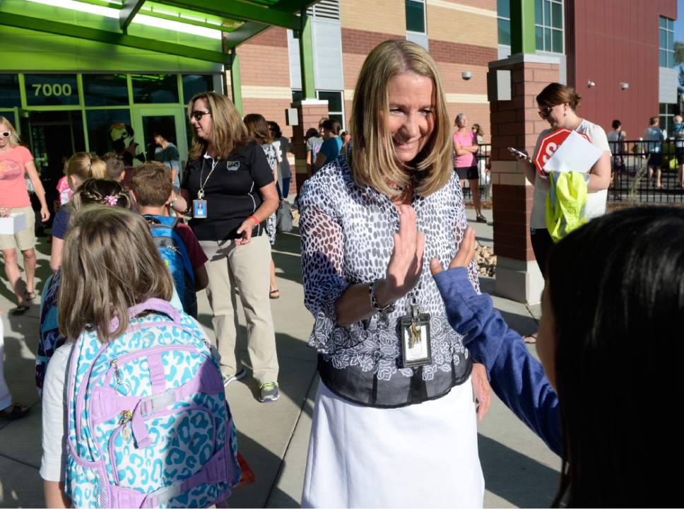Al Hartmann  |  The Salt Lake Tribune
Every student is greeted with a high five and smile by Princiapl Christy Waddell as they enter the brand new Butler Elementary in Cotonwood Heights Wenesday March 25.  It is one of hundreds of schools that opened Wednesday as students gear up for the 2016-2017 school year.