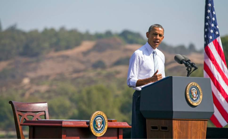 FILE - In this Oct. 10, 2014 ,file photo, President Barack Obama speaks at Frank G. Bonelli Regional Park in San Dimas, Calif., as he designated the nearly 350,000 acres within the San Gabriel Mountains northeast of Los Angeles a national monument. Obama is granting national monument status to nearly 1.8 million acres of scenic California desert wilderness, a move the White House says will set it aside in perpetuity for hikers, campers and hunters as well as protect the region's fragile ecosystem and natural resources. Obama, in California this week for a fund-raising swing, plan to make the announcement Friday, Feb. 12, 2016. In all, Obama will name three specific regions national monuments Mojave Trails, Castle Mountains (both in the Mojave Desert) and Sand to Snow in the Sonoran Desert. (AP Photo/Evan Vucci, File)