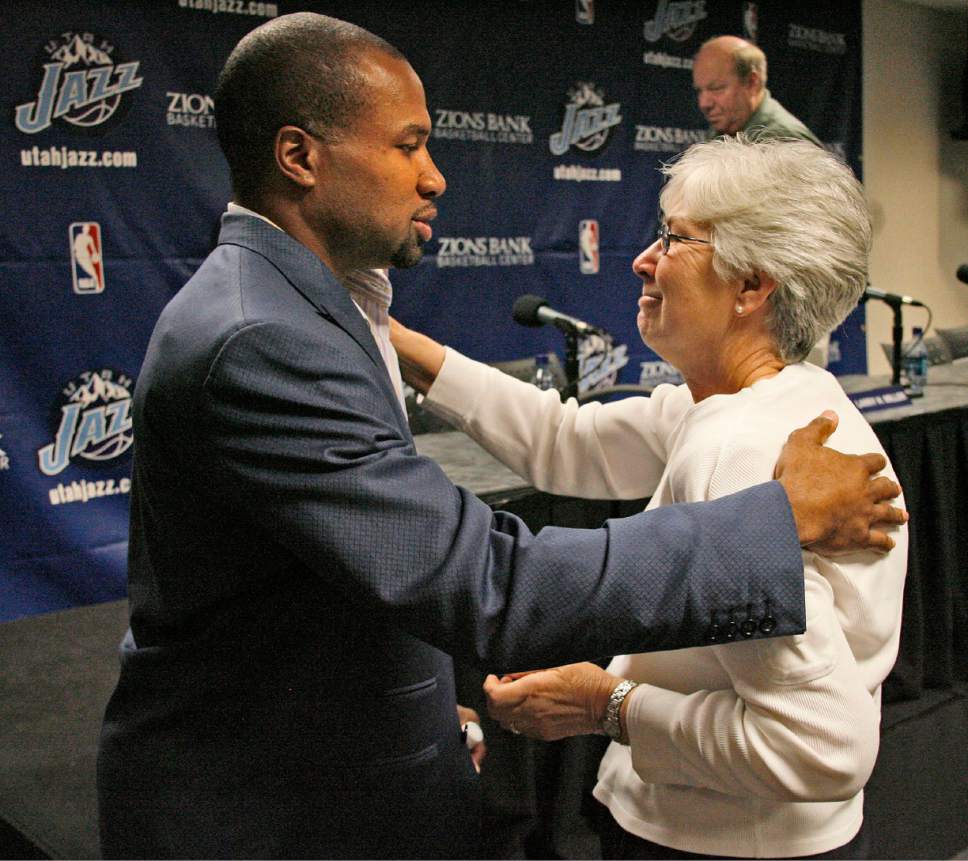 Utah Jazz guard Derek Fisher embraces Gail Miller as her husband and Utah Jazz owner Larry H. Miller (back) leaves the podium following a press conference announcing that Fisher has requested to be released from his contract due to his daughter Tatum's ongoing medical condition July 2, 2007 at the Zions Bank Basketball Center in Salt Lake City.   Steve Griffin/The Salt Lake Tribune