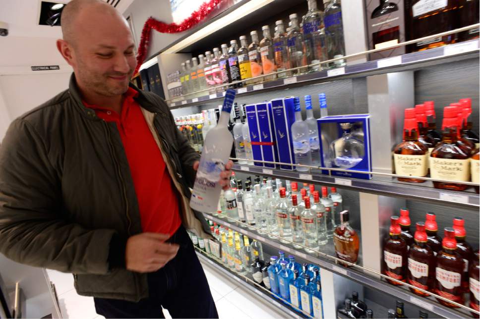 Scott Sommerdorf   |  The Salt Lake Tribune  
Simon Robson chooses a large bottle of Grey Goose Vodka from the Duty Free Americas shop at the Salt Lake City International Airport, Concourse D, Thursday, Dec. 29, 2016. There are also minibottles for sale at the shop.
