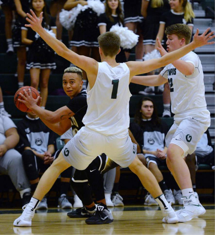 Steve Griffin / The Salt Lake Tribune

Highland's Elijah Shelton looks to pass out of trouble as Olympus applies a full court press during game at Olympus High School in Salt Lake City Tuesday December 20, 2016.