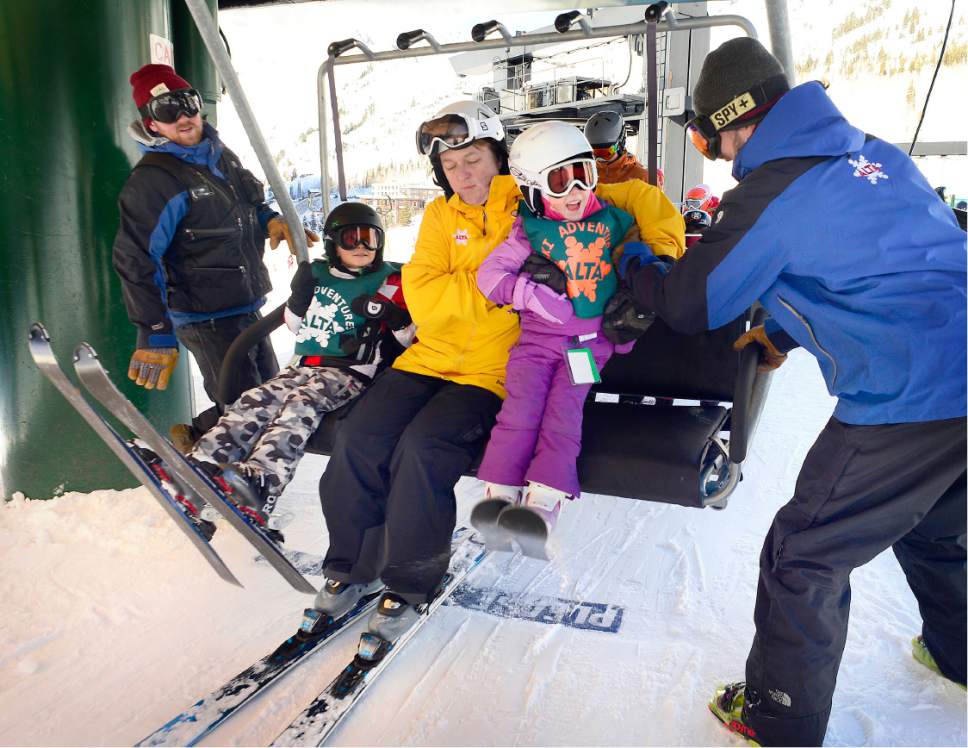 Scott Sommerdorf   |  The Salt Lake Tribune  
"Lifties" Sam Woodman, left, and Matt Nevorsky, right, help load skiers onto the lift chairs at the Sunnyside lift at Alta, Sunday, January 1, 2017.