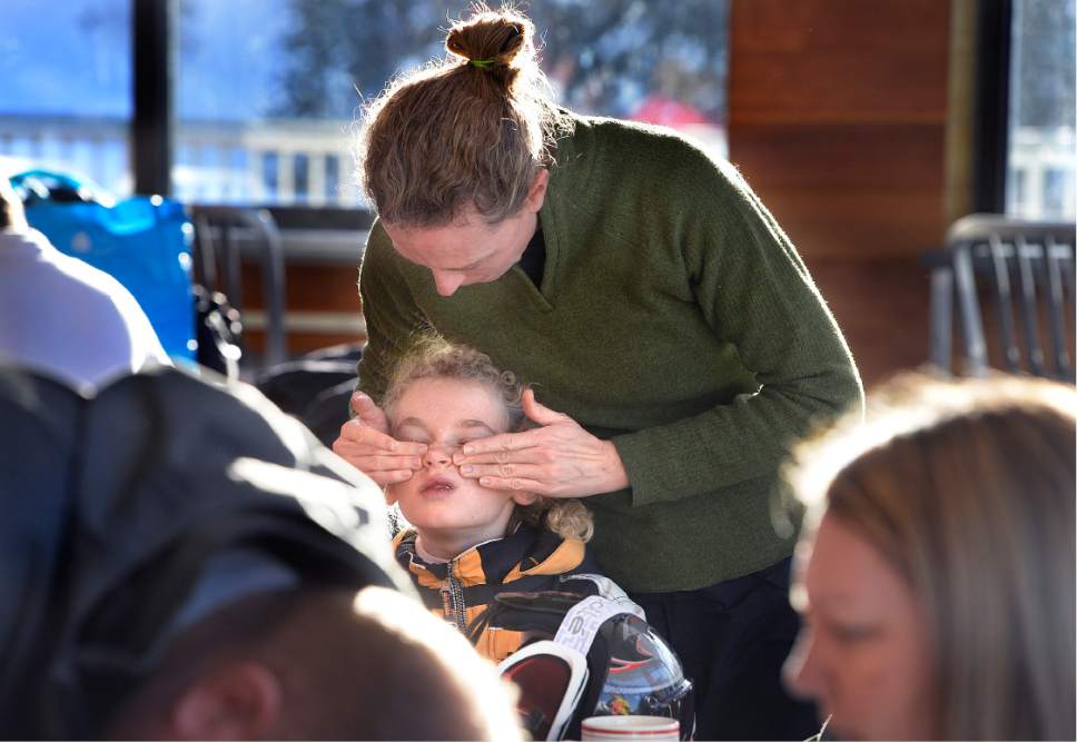 Scott Sommerdorf   |  The Salt Lake Tribune  
Amanda Lichtenstein applies sunscreen to her daughter Kendall at the Albion Grill, in preparation for their New Years Day of skiing at Alta, Sunday, January 1, 2017.