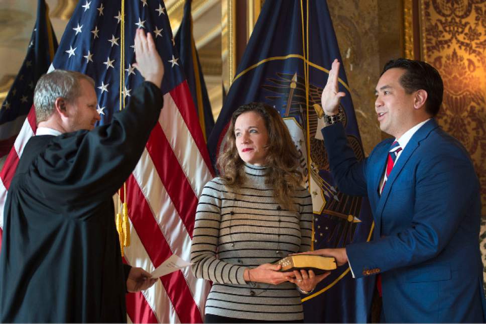 Steve Griffin | The Salt Lake Tribune

Utah Attorney General Sean Reyes, right, is joined by his wife, Saysha, as Utah Supreme Court Justice John A. Pearce administers the oath of office during a simple ceremony in the State Capitol Gold Room in Salt Lake City Monday, Jan. 2, 2017.