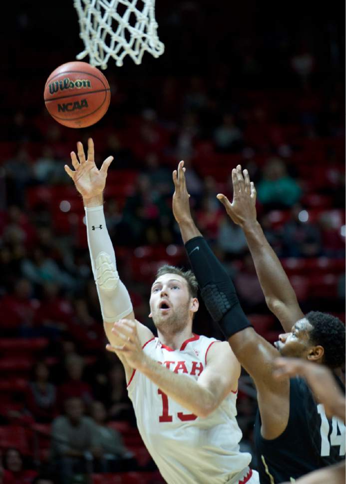 Lennie Mahler  |  The Salt Lake Tribune

Utah forward David Collette shoots over Colorado's Tory Miller in the second half of a game against the Colorado Buffaloes on Sunday, Jan. 1, 2017, at the Huntsman Center in Salt Lake City.