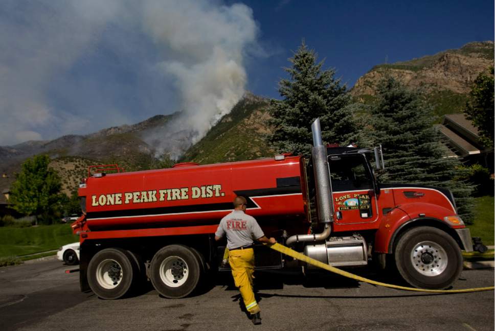 |  Tribune File Photo

Mike Stevens from Lone Peak Fire fills up a pumper truck with water that will be used to contain the Quail Wildfire that is burning in the hills above Alpine, Utah on July 4, 2012.