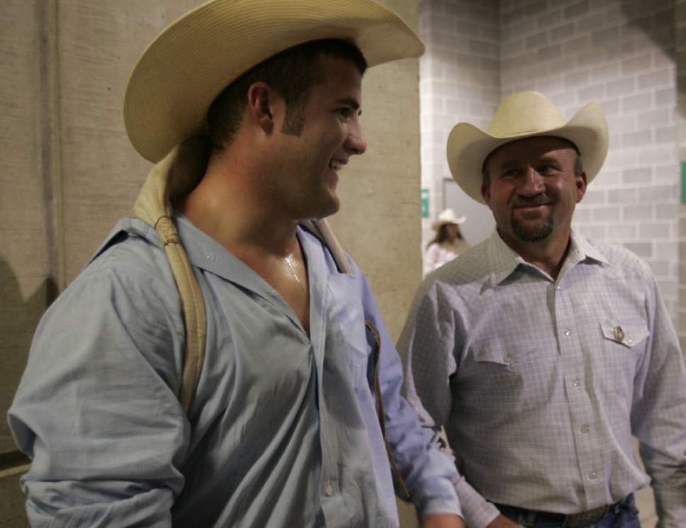 |  Tribune File Photo

Kaycee Feild, left,  of Elk Ridge, talks with his father Lewis Feild, a five time rodeo world title holder, after riding in the bareback riding portion Wednesday July 16, 2008.