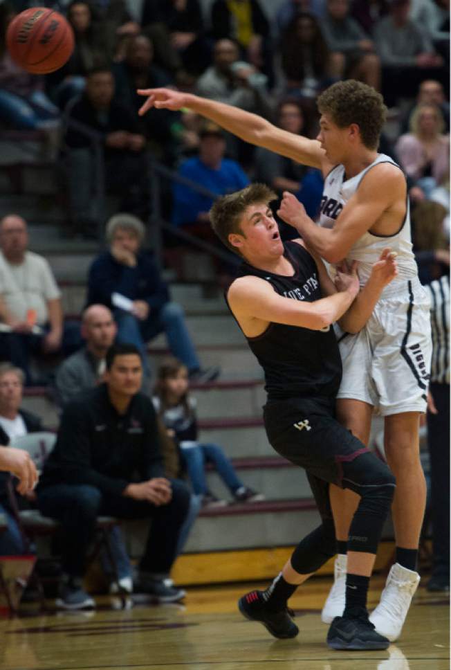 Steve Griffin / The Salt Lake Tribune

Jordan's Dyson Koehler passes over the top of Lone Peak's Max Brenchley during boys basketball game at Jordan High School in Sandy Wednesday January 4, 2017.