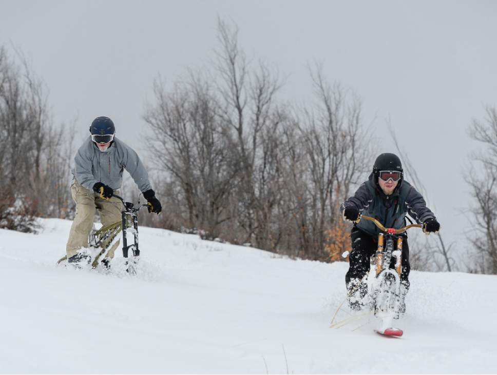 Francisco Kjolseth  |  The Salt Lake Tribune
Playing in the snow, Mike Kerr, left, and Taylor Hobson ski bike off the top of Emigration Canyon on Wednesday.