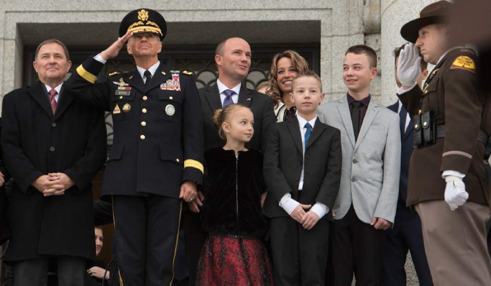 Leah Hogsten  |  The Salt Lake Tribune
l-r Utah Gov. Gary Herbert, Major General Jeff Burton and Lt. Gov. Spencer Cox and family watch as the Utah National Guard howitzers fire off a 19-gun salute and helicopters fly over at the conclusion of the 2017 State Inaugural Ceremony for Gov. Gary R. Herbert, January 4, 2017 at the Utah State Capitol.