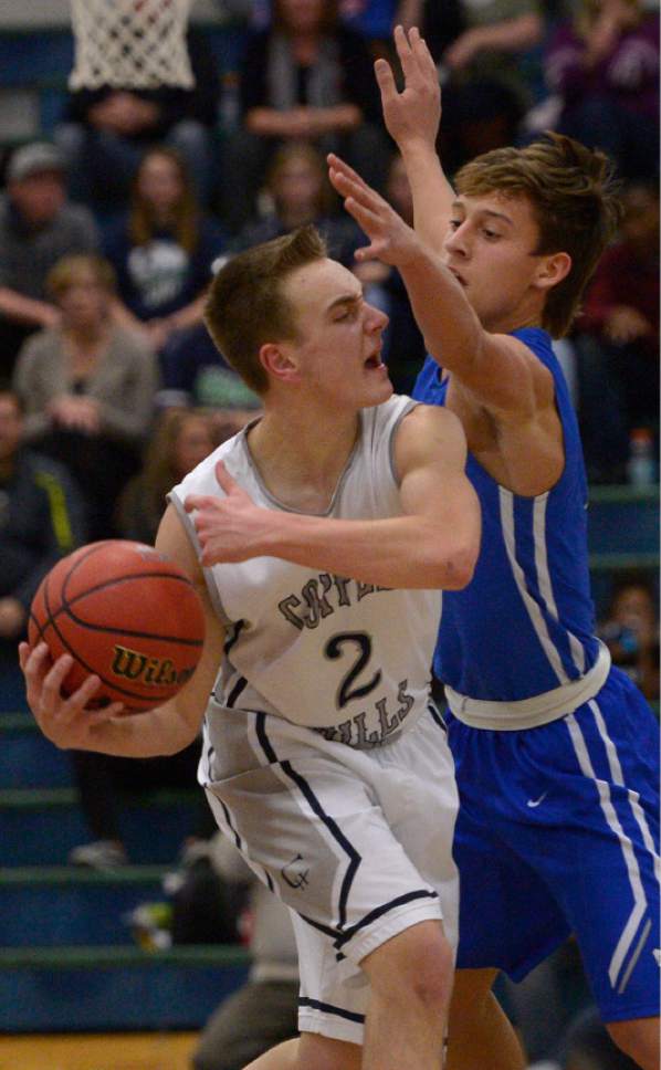 Leah Hogsten  |  The Salt Lake Tribune
Copper Hills' Callahan Blackham is pressured by Bingham's Dax Milne.  Copper Hills High School defeated Bingham High School 59-57 during their game that went into overtime Friday, January 6, 2017 at Copper Hills.