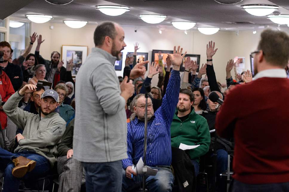 Trent Nelson  |  The Salt Lake Tribune
Members of an overflow crowd raise their hands to the question of who doesn't support the creation of a homeless shelter in Sugar House as Salt Lake City officials appear before the Sugar House Community Council at the Sprague Library in Salt Lake City on Wednesday, Jan. 4, 2017. Addressing the proposed shelter at 653 E. Simpson Ave., Mayor Jackie Biskupski said Tuesday that the site could conceivably be "rethought," even if the city hasn't changed its mind.