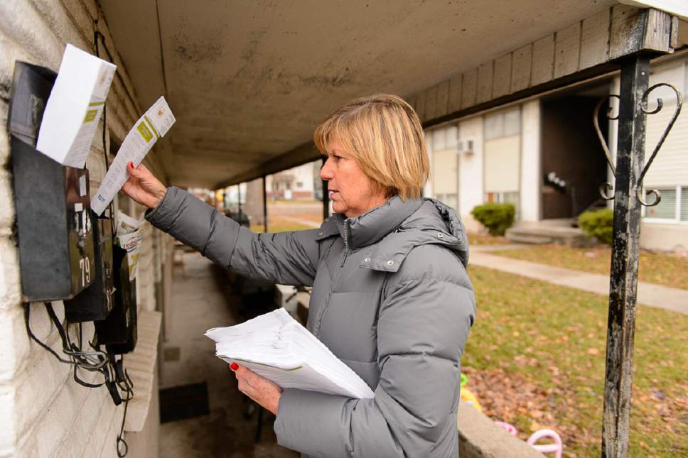 Trent Nelson  |  The Salt Lake Tribune
Salt Lake City Councilwoman Lisa Adams goes door-to-door in the area around 653 E. Simpson Avenue to explain to residents what they should expect from the planned homeless shelter at that address, Wednesday December 14, 2016. She was accompanied by a police officer after receiving threatening emails.