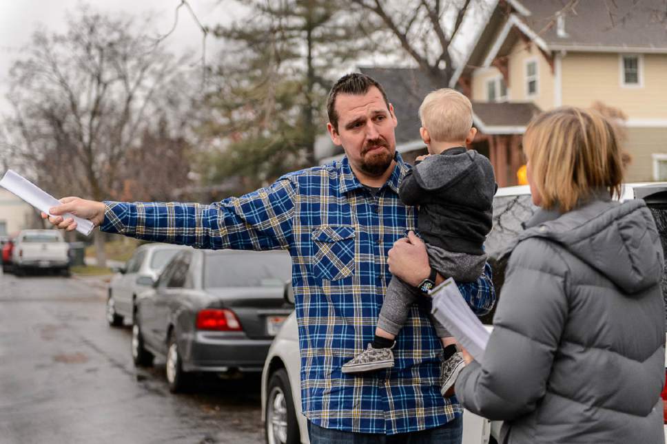 Trent Nelson  |  The Salt Lake Tribune
Salt Lake City resident Chris Sveiven, holding his son Weston, expresses his displeasure Dec. 14 over the announced homeless shelter at 653 E. Simpson Avenue to Councilwoman Lisa Adams. "This is a nightmare," Sveiven said. Adams went door-to-door in the area to hear from and explain to residents what they should expect from the planned homeless shelter at that address. Adams was accompanied by a police officer after receiving threatening emails.