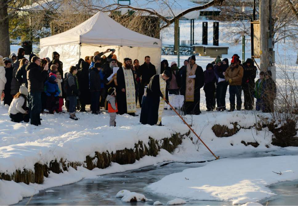 Steve Griffin / The Salt Lake Tribune

Father Anthony Savas dips a long cross into the water as Greek Orthodox gather at Sugar House Park in Salt Lake City for the Theophany Blessing of the Water Jan. 6, 20017. Orthodox Christians celebrate the Feast of Theophany (known as Epiphany by Western Christians)  is the 12th day of Christmas and commemorates Jesus Christ's revelation as God. While some Christians emphasize the three wise men reaching the Christ child, Orthodox Christians remember his baptism in the Jordan River and God's revelation that Jesus was his son.