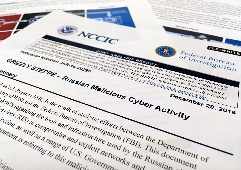 The first page of the Joint Analysis Report narrative by the Department of Homeland Security and federal Bureau of Investigation and released on Dec. 29, 2016, is photographed in Washington, Jan. 6, 2017. Computer security specialists say the technical details in the narrative that the U.S. said would show whether computers had been infiltrated by Russian intelligence services were poorly done and potentially dangerous. Cybersecurity firms ended up counseling their customers to proceed with extreme caution after a slew of false positives led back to sites such as Amazon and Yahoo Inc. Companies and organizations were following the government's advice Dec. 29 and comparing digital logs recording incoming network traffic to their computers and finding matches to a list of hundreds of internet addresses the Homeland Security Department had identified as indicators of malicious Russian intelligence services cyber activity. (AP Photo/Jon Elswick)