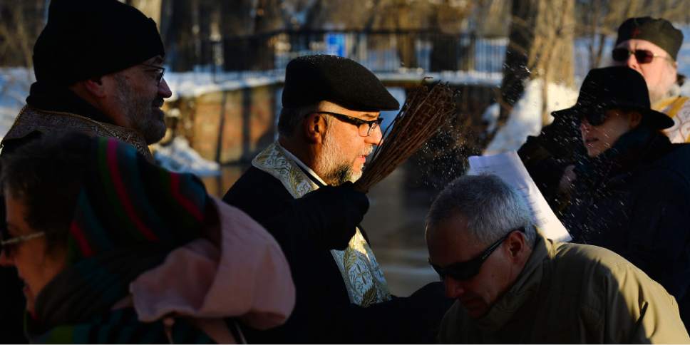 Steve Griffin / The Salt Lake Tribune

Father Elias Koucos and Father Anthony Savas give blessings as Greek Orthodox gather at Sugar House Park in Salt Lake City for the Theophany Blessing of the Water Jan. 6, 20017. Orthodox Christians celebrate the Feast of Theophany (known as Epiphany by Western Christians)  is the 12th day of Christmas and commemorates Jesus Christ's revelation as God. While some Christians emphasize the three wise men reaching the Christ child, Orthodox Christians remember his baptism in the Jordan River and God's revelation that Jesus was his son.
