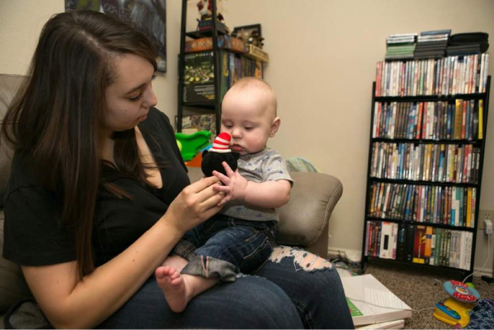 Jud Burkett special to The Salt Lake Tribune

Kaitlyn, who was sexually assaulted as a freshman at Southern Utah University, plays with her 5-month-old son at the Cedar City home they share with her husband. She agreed to the use of her first name. Unlike many college students who are assaulted, Kaitlyn stayed in classes at her school, and she graduated in December. Cedar City police told her that her assailant had been banned from campus, which she said helped her feel safe and focus on school.