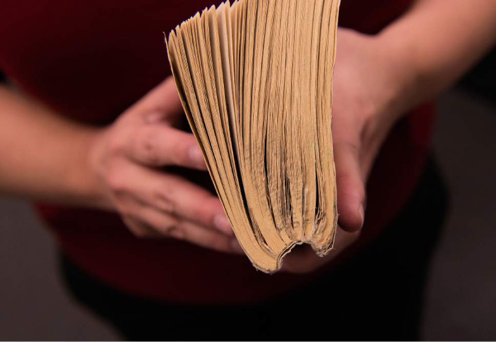 Leah Hogsten  |  The Salt Lake Tribune
Utah State Prison librarian, Christie Jensen, shows one of the well-loved books with a semi-circled spine. Jensen and her staff maintain and repair books on site.