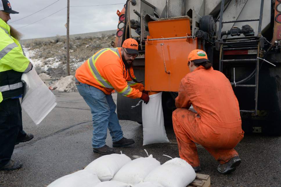 Al Hartmann  |  The Salt Lake Tribune
UDOT employees Eric Cottrell, left, Tim Lombardie and Christian Graneros fill sandbags in preparation for possible flooding along freeways or state highways from our recent wet weather. UDOT says it is not anticipating problems, but wants to be prepared.