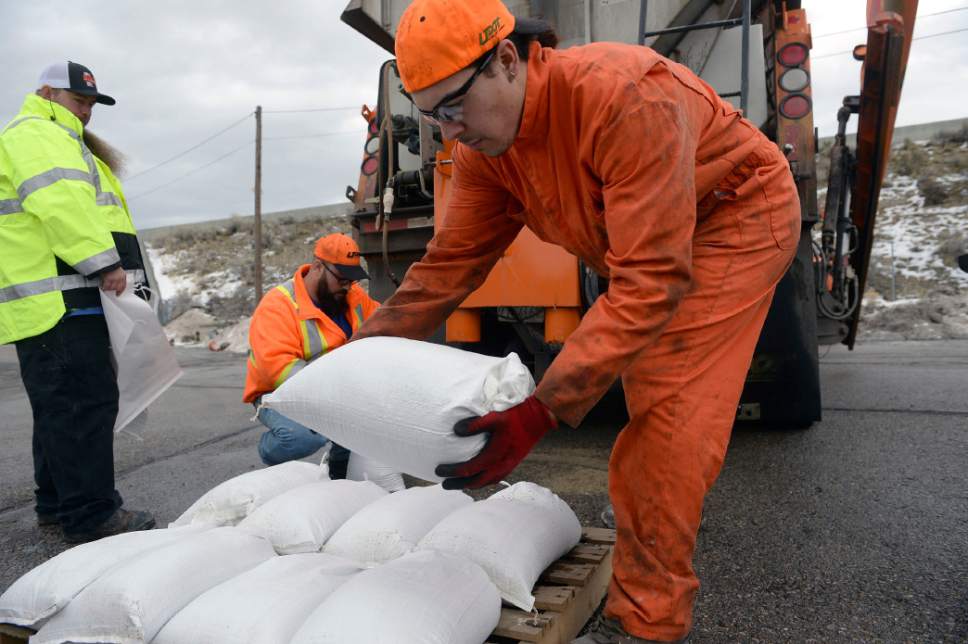 Al Hartmann  |  The Salt Lake Tribune
UDOT employees Eric Cottrell, left, Tim Lombardie and Christian Graneros fill sandbags in preparation for possible flooding along freeways or state highways from our recent wet weather. UDOT says it is not anticipating problems, but wants to be prepared.