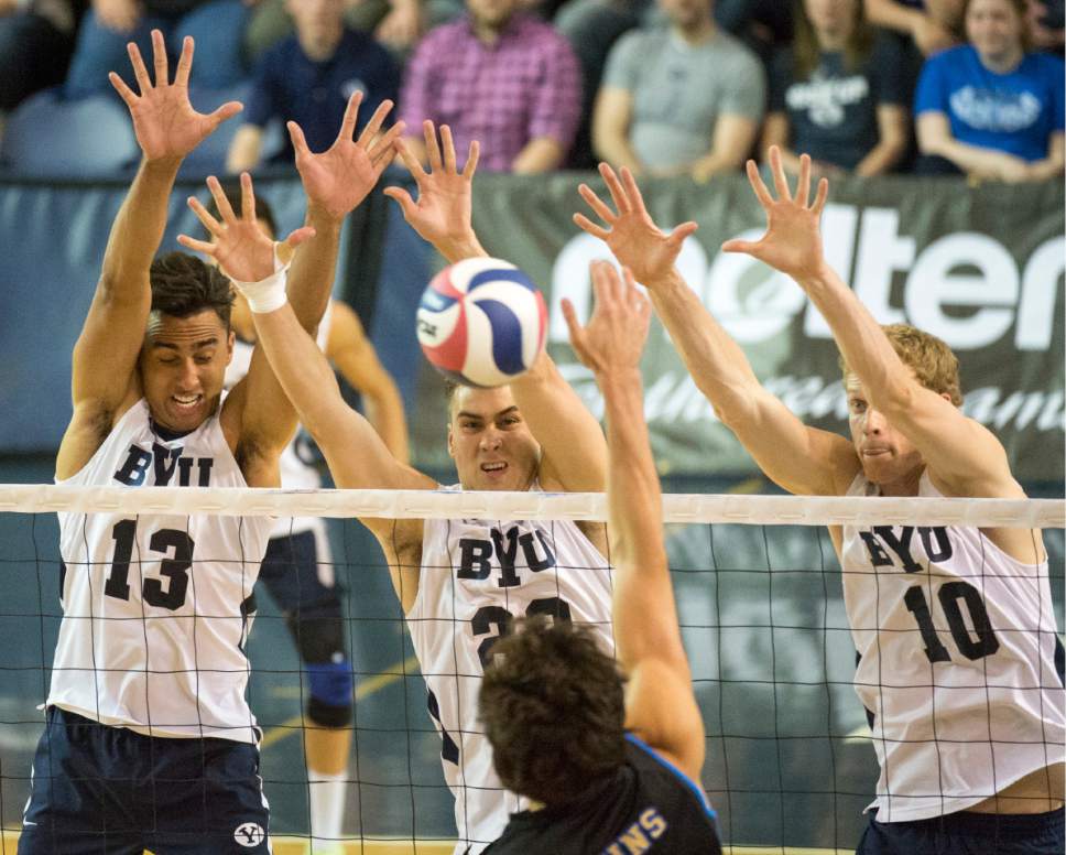 Rick Egan  |  The Salt Lake Tribune

Brigham Young Cougar defenders, Ben Patch (13), Brigham Young Cougars Michael Hatch (23), and Jake Langlois (10) go up for a block, in BYU's victory in the Mountain Pacific Sports Federation Volleyball Championship game,  in tournament action at the Smith Field House in Provo, Saturday, April 23, 2016.