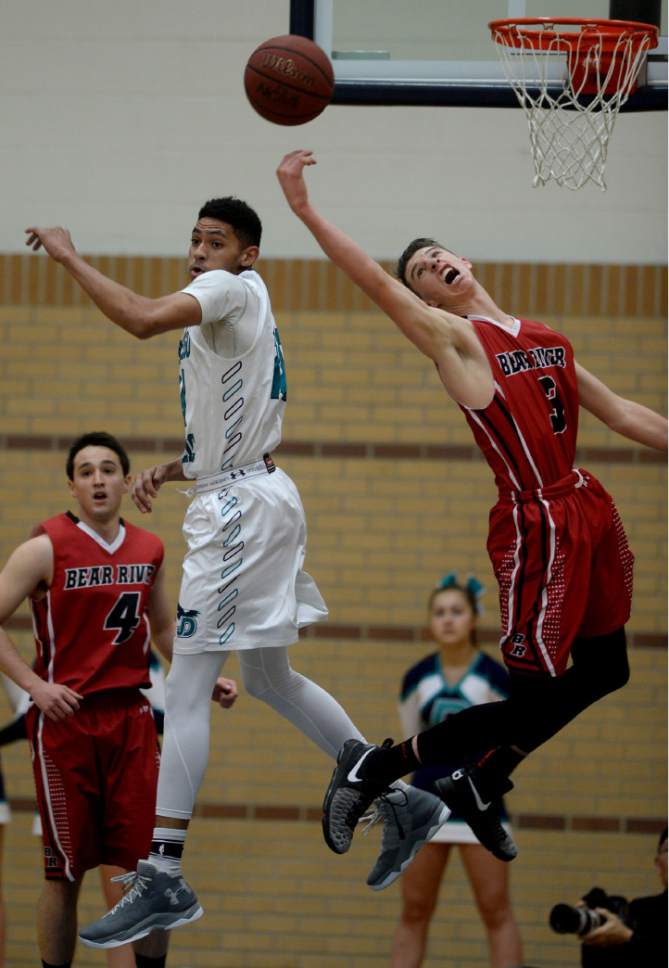 Steve Griffin / The Salt Lake Tribune

Juan Diego's Steven Price and Bear River's Jake Dadhle reach for the ball during game against Juan Diego  at Juan Diego Catholic High School in Draper Wednesday January 11, 2017.