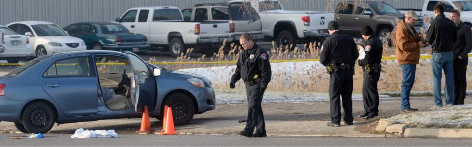 Al Hartmann  |  The Salt Lake Tribune 
West Valley City Police investigate shooting scene at 4900 West off the frontage road to SR 201 where a husband shot his wife in the car and then shot himself.  Both are in critical condition.