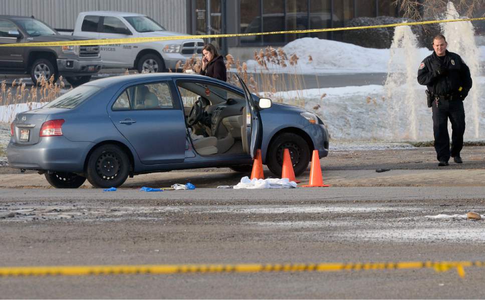 Al Hartmann  |  The Salt Lake Tribune 
West Valley City Police investigate shooting scene at 4900 West off the frontage road to SR 201 where a husband shot his wife in the car and then shot himself.  Both are in critical condition.