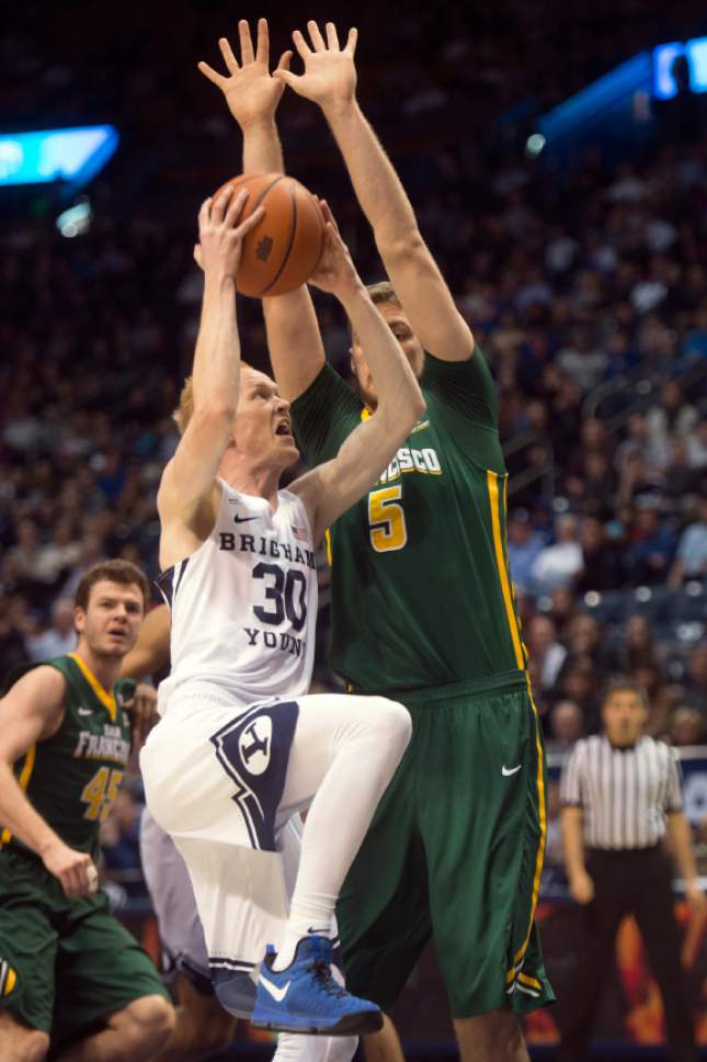 Chris Detrick  |  The Salt Lake Tribune
Brigham Young Cougars guard TJ Haws (30) shoots past San Francisco Dons center Jimbo Lull (5) during the game at the Marriott Center Thursday January 12, 2017.