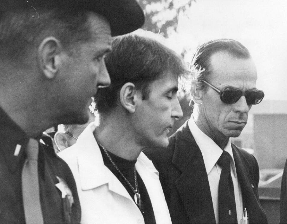 |  Tribune File Photo

The police officials are taking Gary Gilmore into custody December 16, 1976.
