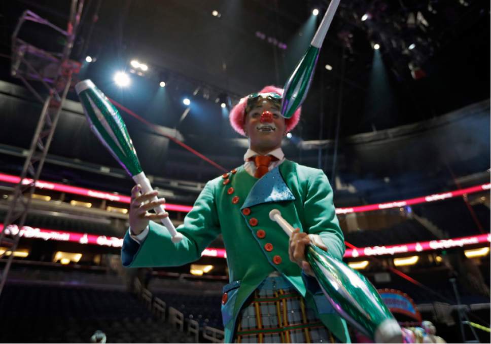 A Ringling Bros. and Barnum & Bailey clown juggles for fans during a pre show Saturday, Jan. 14, 2017, in Orlando, Fla. The Ringling Bros. and Barnum & Bailey Circus will end the "The Greatest Show on Earth" in May, following a 146-year run of performances. Kenneth Feld, the chairman and CEO of Feld Entertainment, which owns the circus, told The Associated Press, declining attendance combined with high operating costs are among the reasons for closing. (AP Photo/Chris O'Meara)