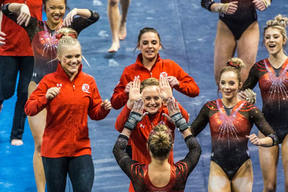 Chris Detrick  |  The Salt Lake Tribune
Tiffani Lewis celebrates with her teammates after competing on the vault during the gymnastics meet against Brigham Young University at the Marriott Center Friday January 13, 2017.
