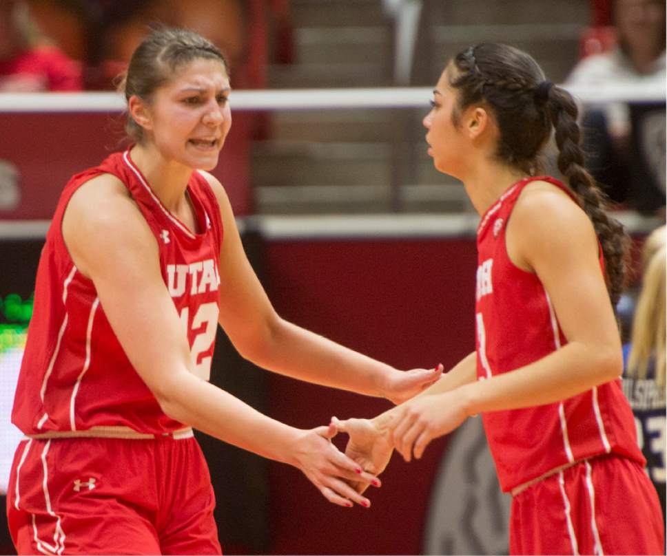 Rick Egan  |  The Salt Lake Tribune

Utah Utes forward Emily Potter (12) shouts its  Malia Nawahine (3), after Nawahine hit a 3-point-shot to tie the game, in Basketball action, Brigham Young Cougars vs. the Utah Utes, Saturday, December 10, 2016.